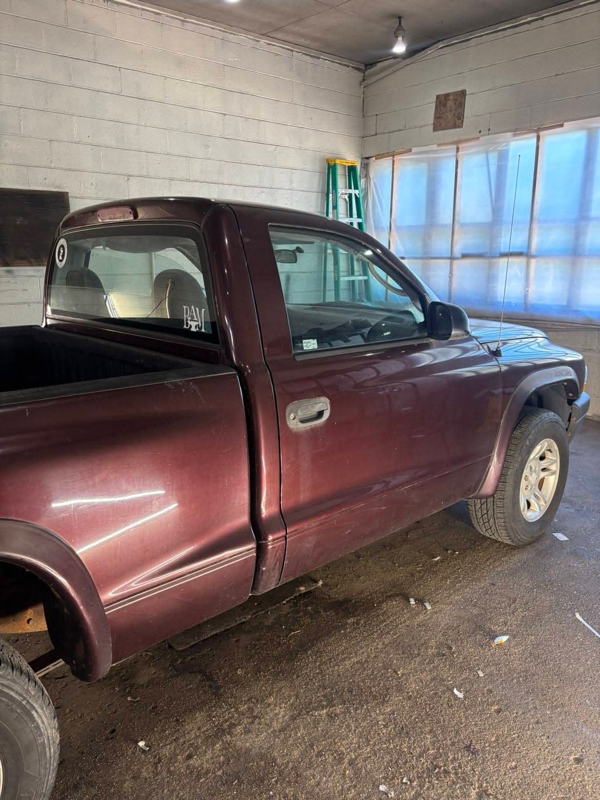 Maroon pickup truck before exterior detailing